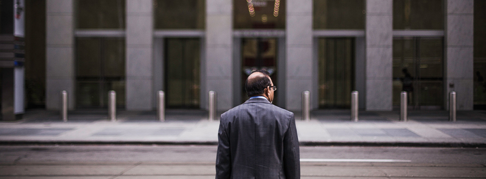 Business man in front of corporate building in the city.